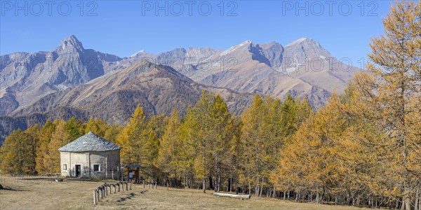 View of Monte Cersogno and Pelvo di Elva in autumn with chapel Chiesa San Giovanni