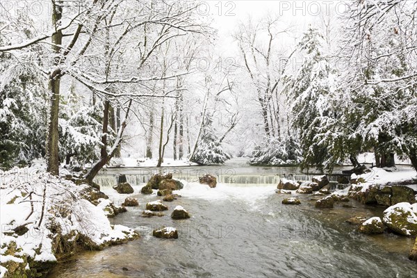 Eisbach with snow-covered trees