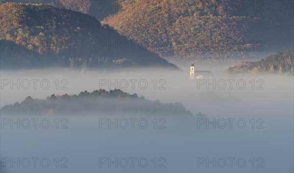 Autumn foggy atmosphere and pilgrimage church at Hafnerberg