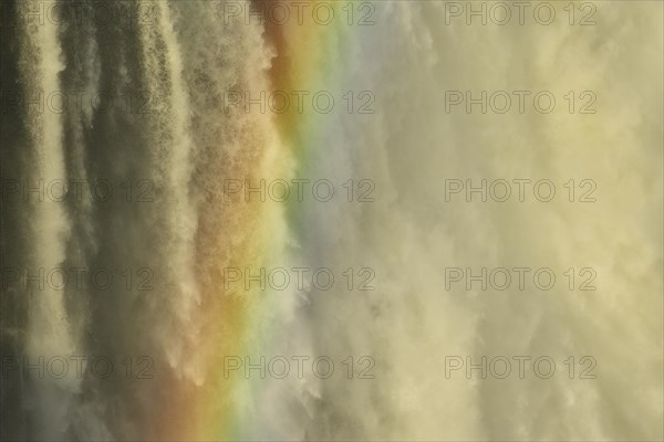 Falling water masses with rainbows