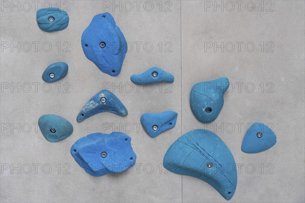 Blue via ferrules or climbing grips on grey wall