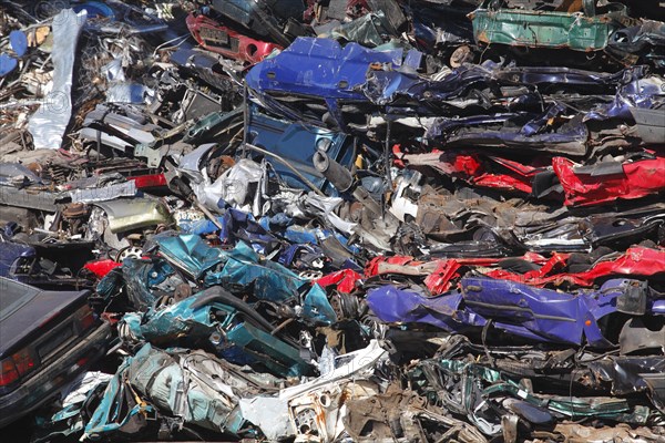 Stacked car wrecks at a scrap yard