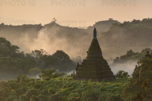 Mist over hills and stupas of Mrauk U at sunrise