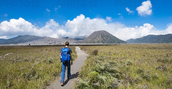 Young man in the caldera on his way to the crater of the Gnung Bromo