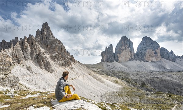 Hiker sits on rock