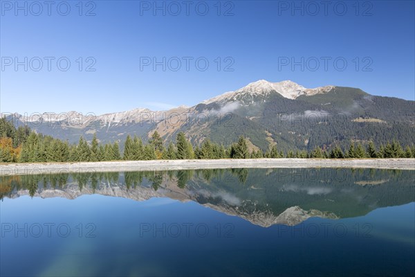 Water reservoir for snow production for the ski slopes on Grubigstein with view to Daniel