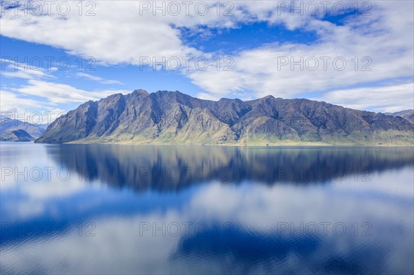 Cloudy sky with water reflections in Lake Hawea