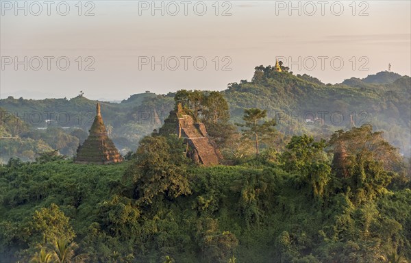 Mist over hills and stupas of Mrauk U at sunset