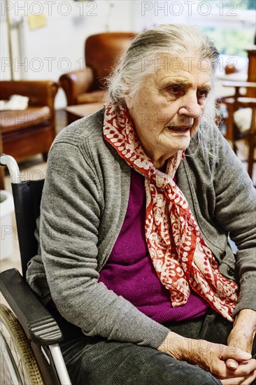 Demented Senior in a wheelchair alone in her room in a nursing home