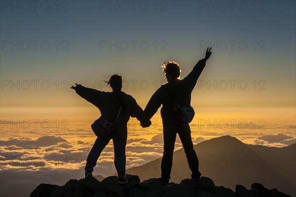 Tourists in backlight waiting for sunset on top of Haleakala National Park