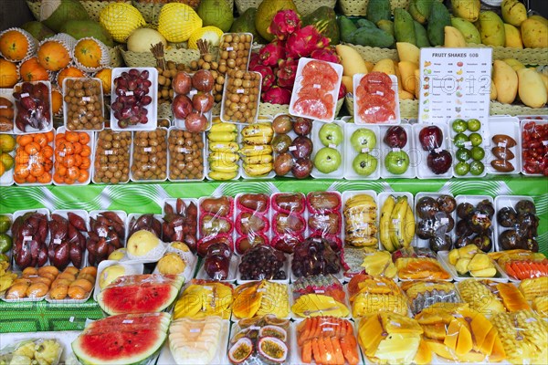 Plastic wrapped fresh fruit at a street stand