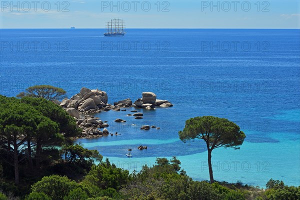 Bay of Palombaggia with turquoise blue sea and sailing ship