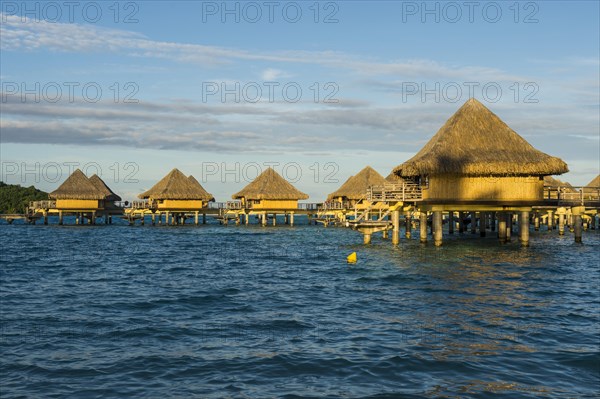 Overwater bungalows on stilts in luxury hotel