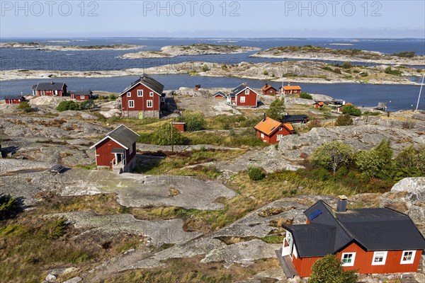 Red wooden houses on the rocky coast