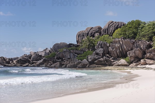 Grand Anse sandy beach with black granite rocks