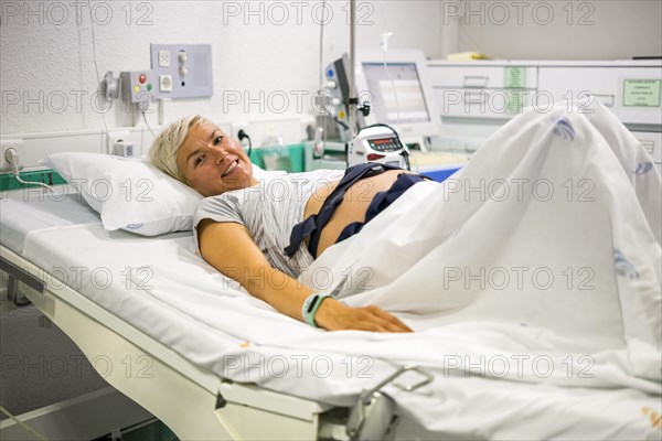 Pregnant woman with ctg recording the fetal heartbeat and the uterine contractions