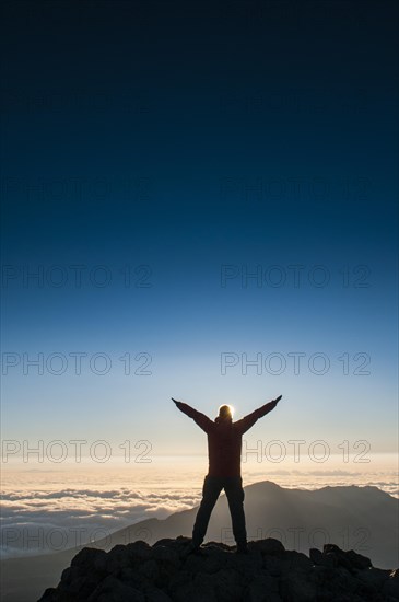 Tourist in backlight waiting for sunset on top of Haleakala National Park