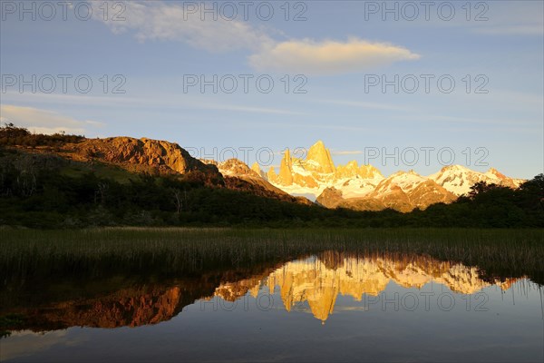 Mountain range with Cerro Fitz Roy at sunrise reflected in Lago de Los Tres