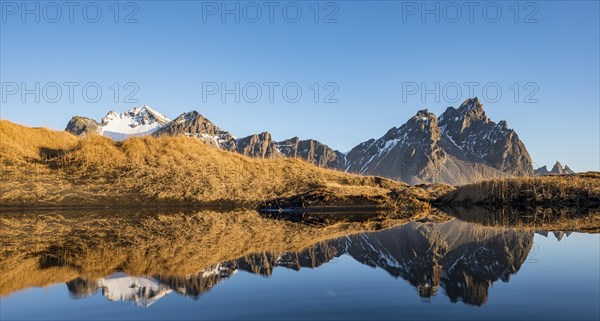 Mountains are reflected in a small lake