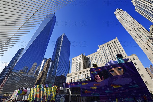 Construction site with graffiti decorated walls in front of the Oculus