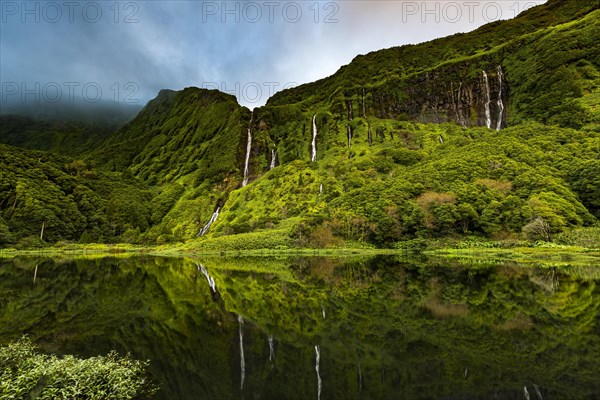 Waterfalls with lake Poco Ribeira do Ferreiro in green landscape