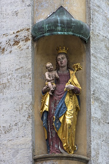 Colored sculpture of the virgin Mary with the baby Jesus under a canopy