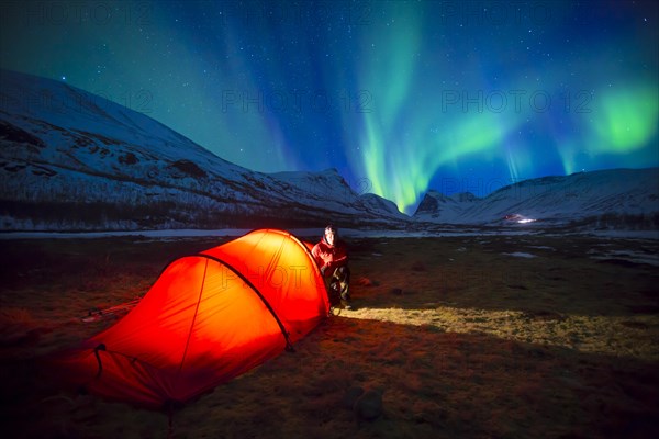 Northern Lights (Aurora borealis) over a tent in winter