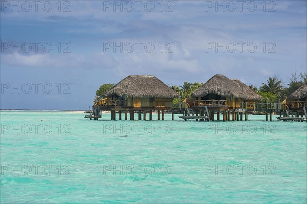 Overwater bungalows on stilts in luxury hotel