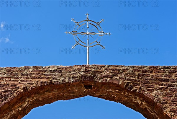 Stylized cross of the orthodox Ethiopian church at the entrance portal to the church Abreha wa Atsbaha