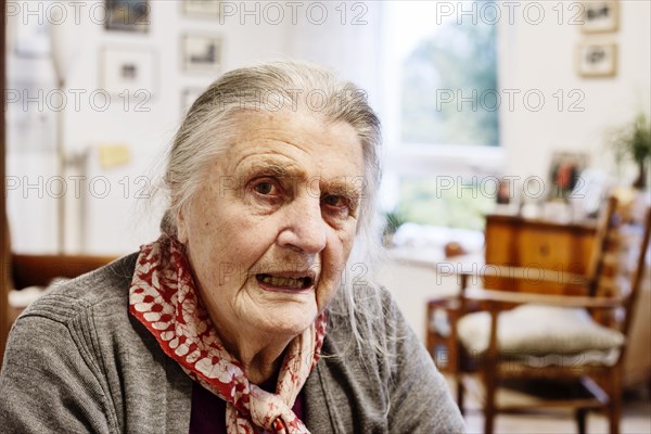 Demented Senior in a wheelchair alone in her room in a nursing home