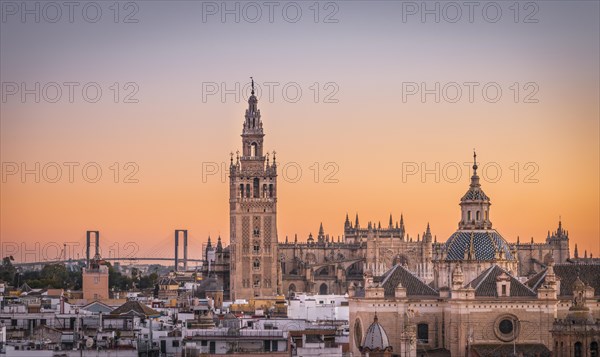 View of La Giralda and Iglesia del Salvador at sunset