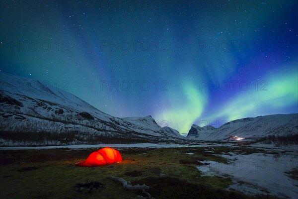 Northern Lights (Aurora borealis) over a tent in winter