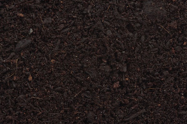Organic potting soil mix enriched with compost abstract background texture closeup of particles