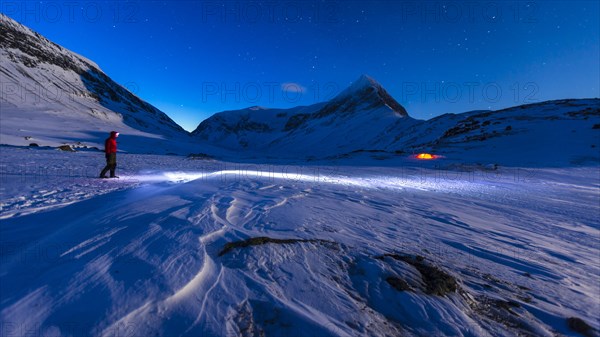 Person with a tent in the snow