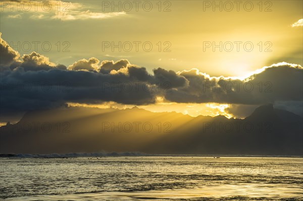 Sun rays breakig through the clouds over Moorea