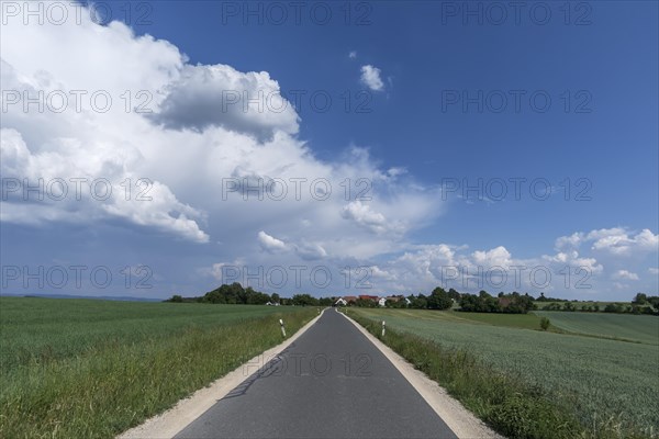 Country road with cloudy sky