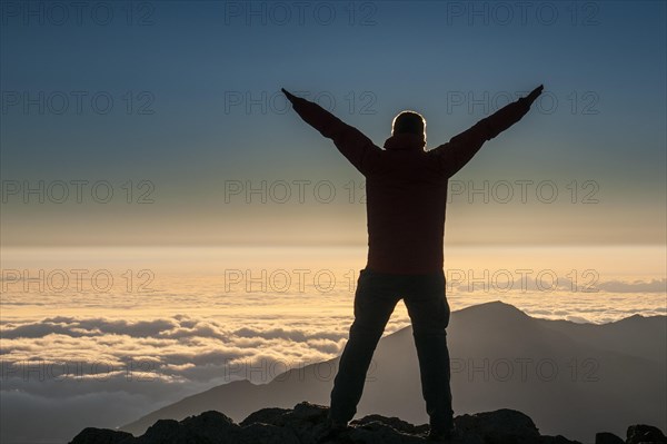 Tourist in backlight waiting for sunset on top of Haleakala National Park