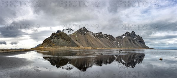 Water reflection at the black sandy beach