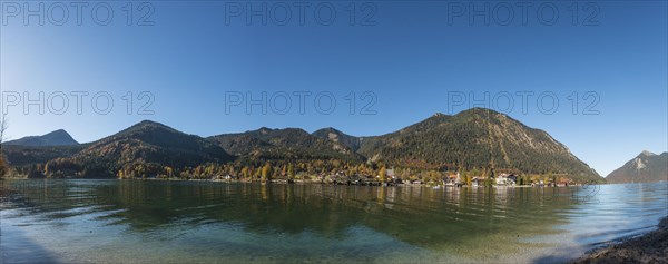 View over the lake with Jochberg and Herzogstand and place Walchensee in autumn