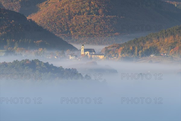 Autumn foggy atmosphere and pilgrimage church at Hafnerberg