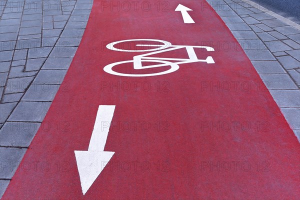 Red cycle path with white markings