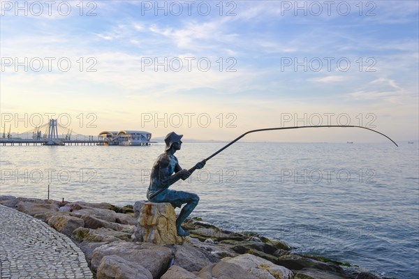 Bronze figure angler on waterfront