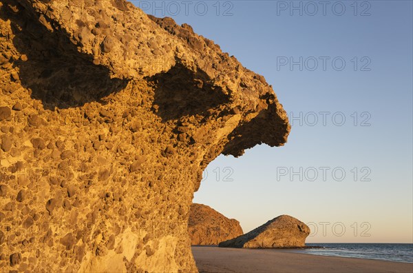 Fossilized lava tongues and walls at the beach Playa del Monsul