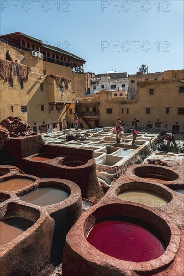 Worker dyeing leather