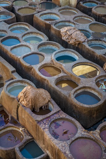 Worker dyeing leather