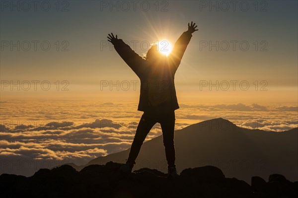 Tourist in backlight waiting for sunset on top of Haleakala National Park