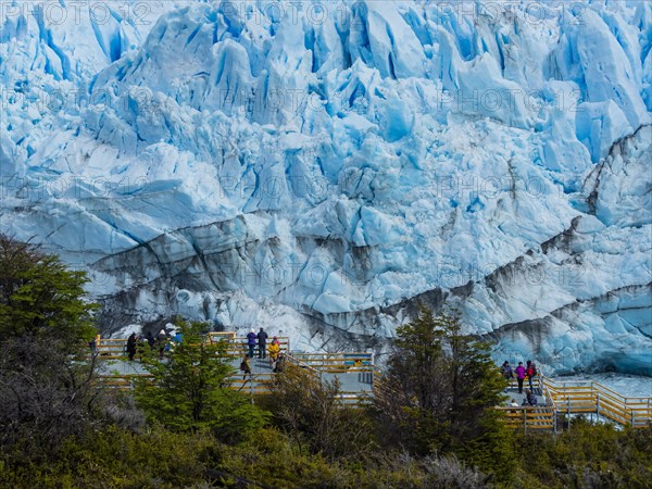 Tourists on a viewing platform at the Perito Moreno glacier