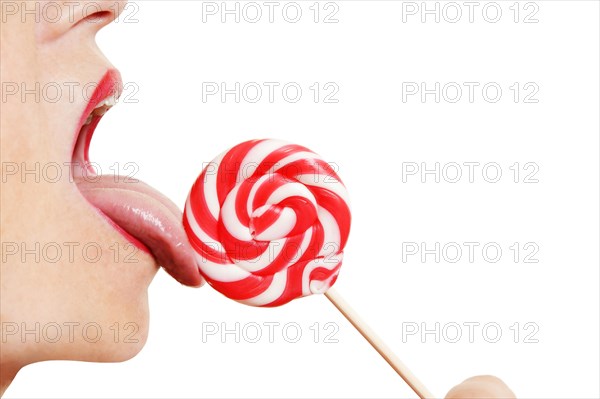 Woman licking a lollipop