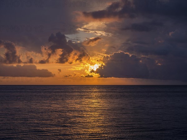 Sunset behind clouds over the sea off the coast of Levanto