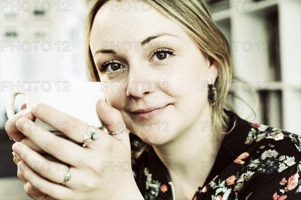 Young woman with a cup of coffee in her hand